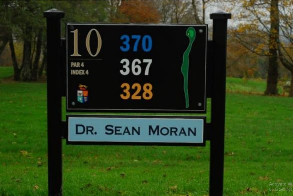 Golf course sign for Hole 10, Par 4, showing yardages of 370, 367, and 328 by Dr. Sean Moran.